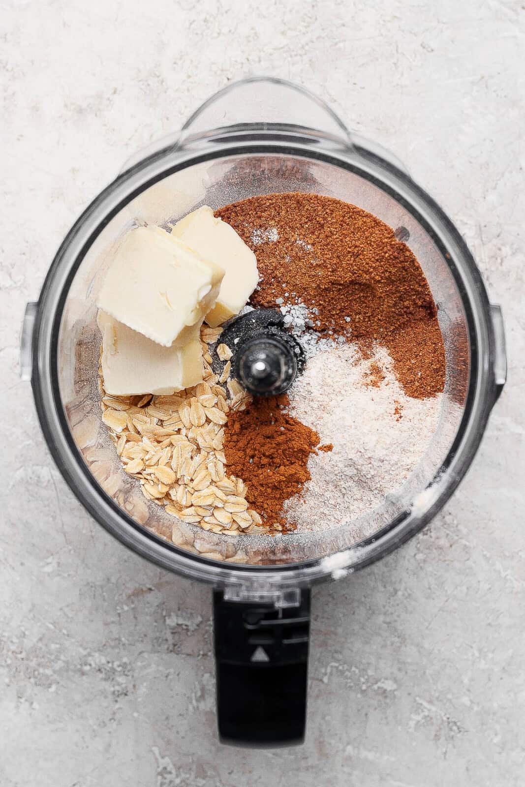 Ingredients for healthy apple crisp topping separated in a food processor.