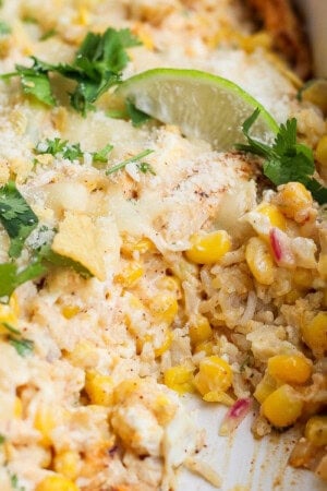 Street corn chicken casserole topped with cilantro, fresh lime, and cojita cheese.