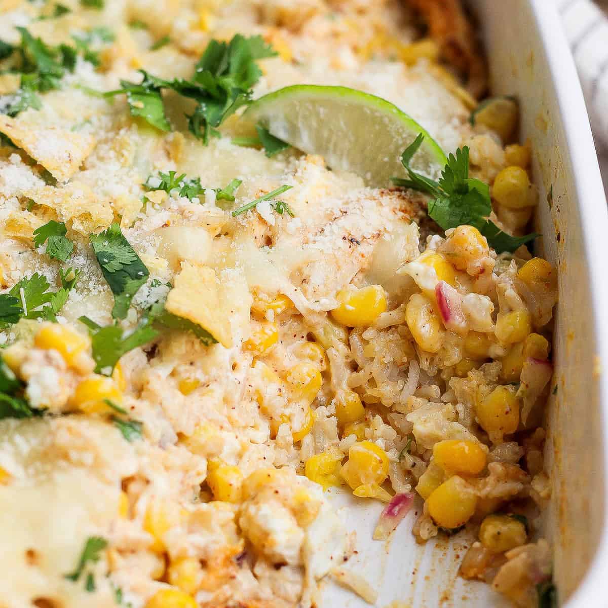 Street corn chicken casserole topped with cilantro, fresh lime, and cojita cheese.