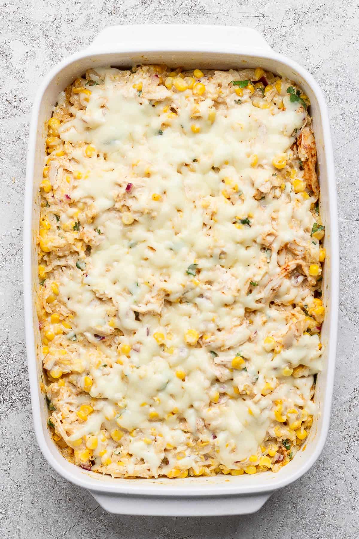 Street corn casserole with melted mozzarella cheese on top.