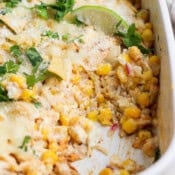 Street corn chicken casserole in a casserole dish with a scoop taken out.