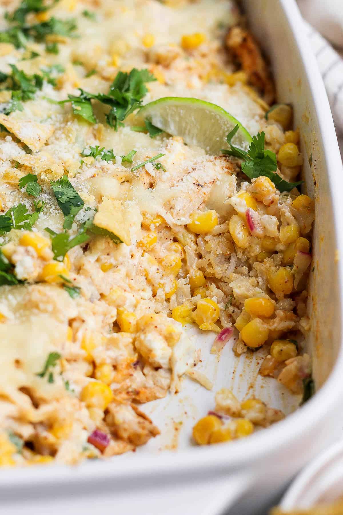 Street Corn Chicken Casserole in a casserole dish with a scoop removed.