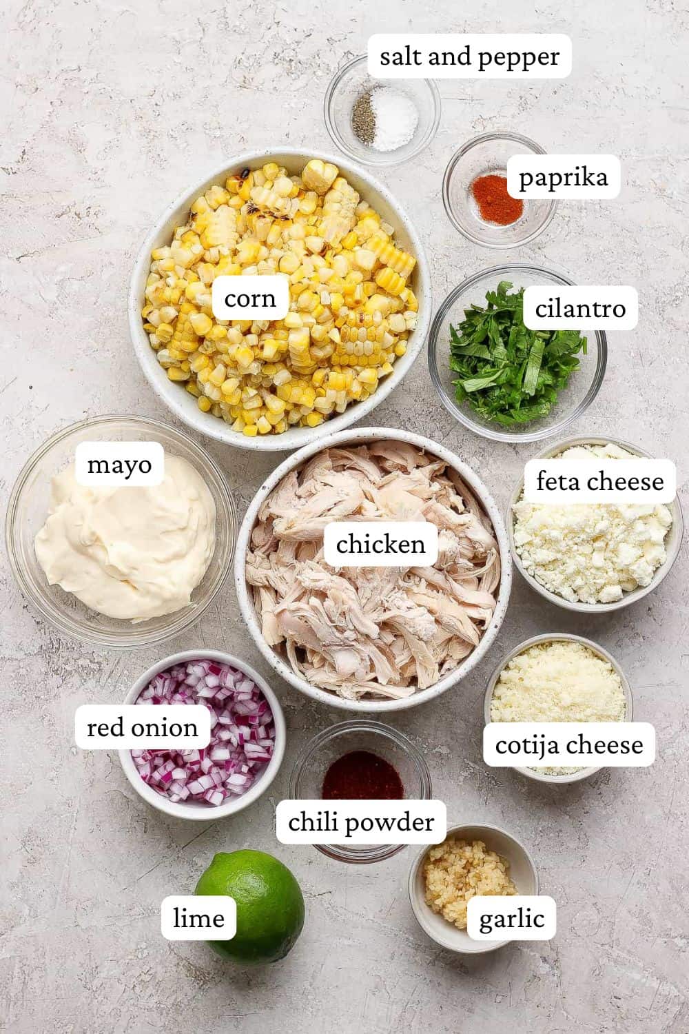 Ingredients for street corn chicken salad in separate bowls with labels.