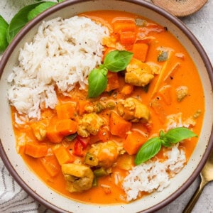 A bowl of sweet potato chicken curry over white rice.