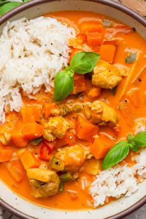 A bowl of sweet potato chicken curry over white rice.