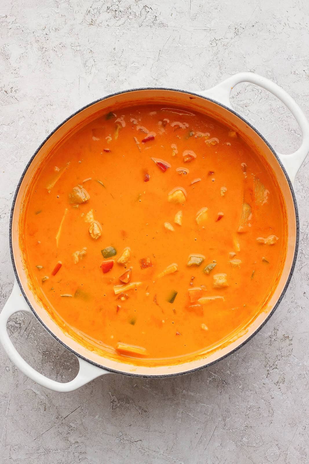 Fully mixed and simmered sweet potato chicken curry in a dutch oven.