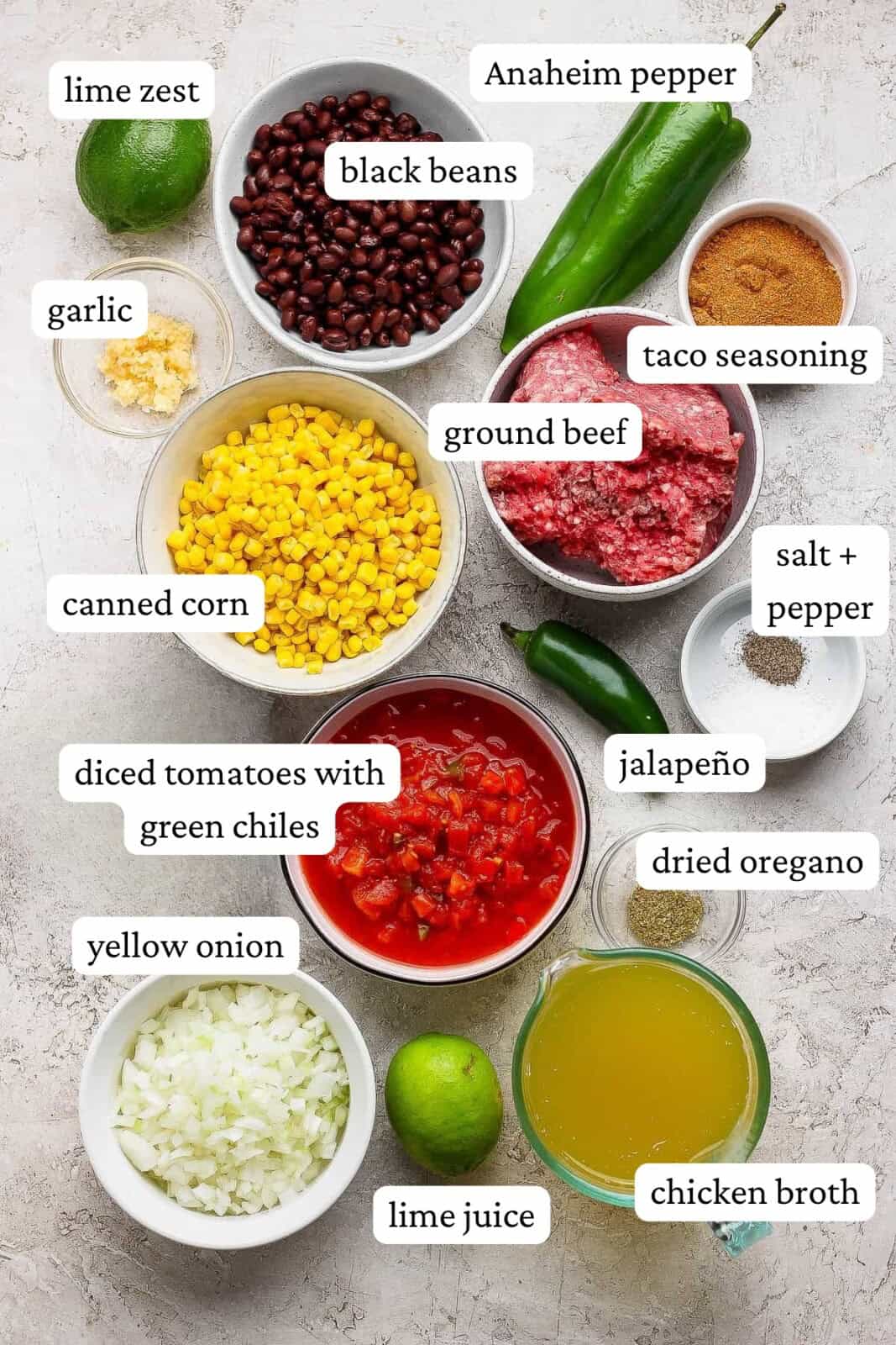 Ingredients for taco soup with ground beef in separate bowls with labels.