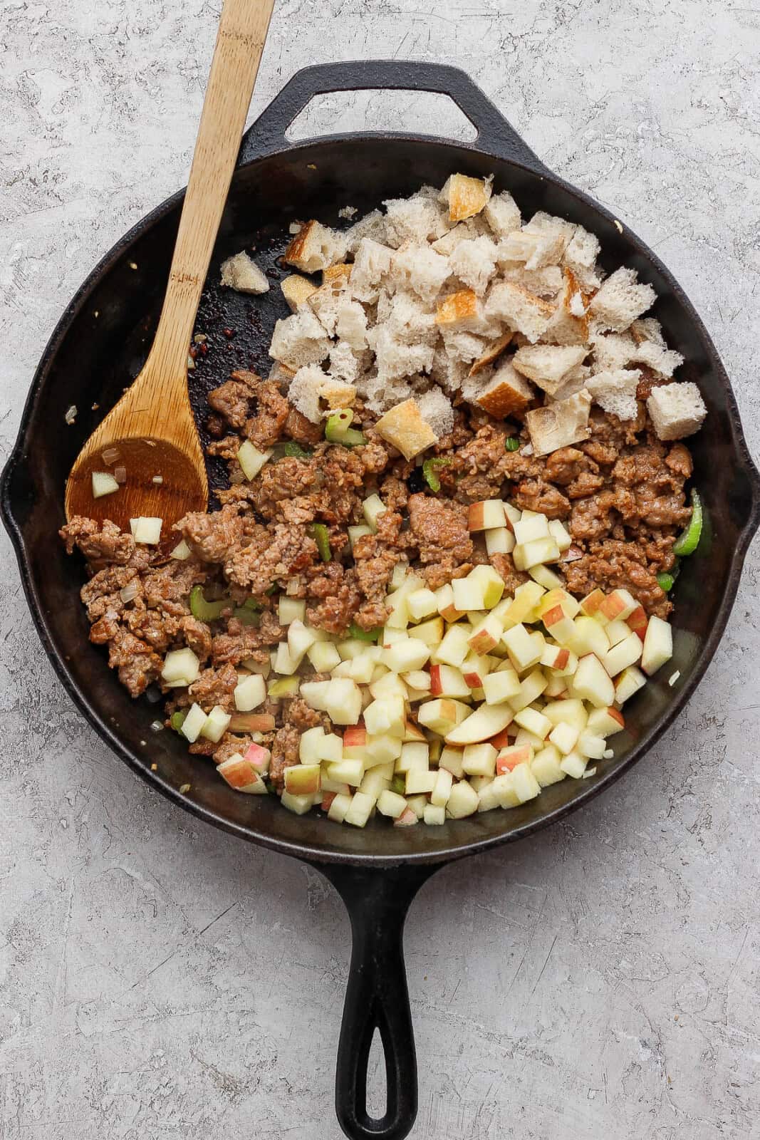 Diced bread, apples, and chicken broth added to the filling mixture for sausage and apple stuffed acorn squash.
