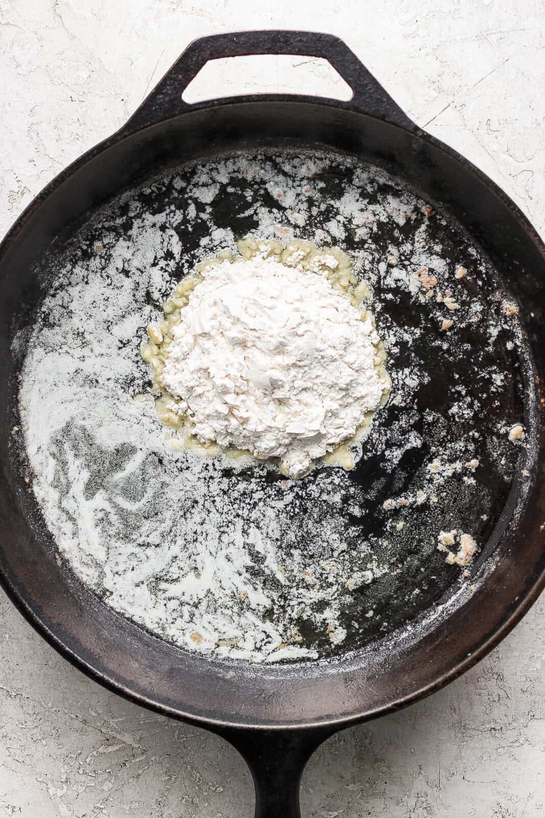 Flour added to melted butter and Swedish meatball pan drippings before being whisked together.
