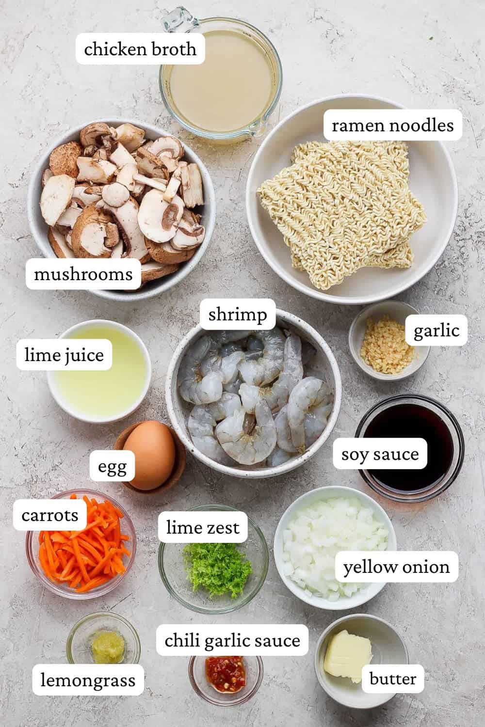Shrimp ramen noodles ingredients in separate bowls with labels.