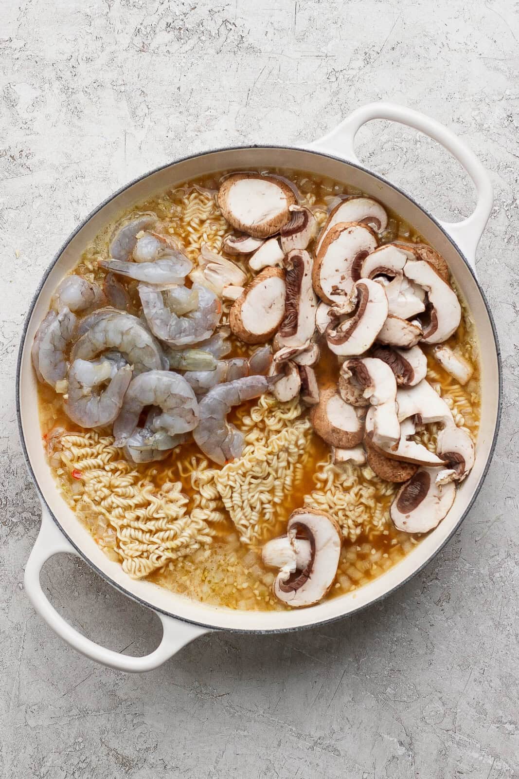 Shrimp and mushrooms added to the broth and noodles for shrimp ramen noodles.