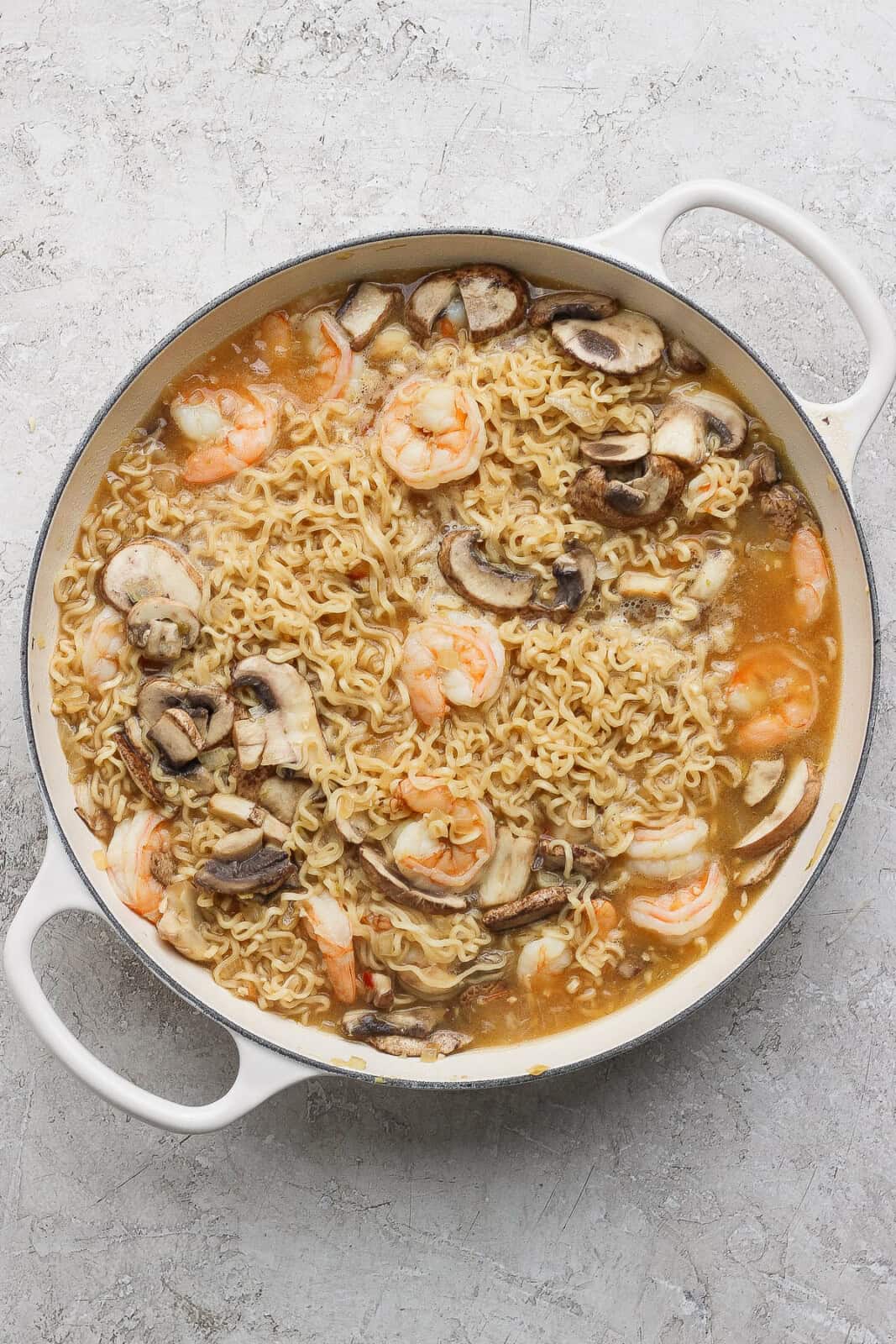 Shrimp ramen noodles fully cooked in a braiser pan.