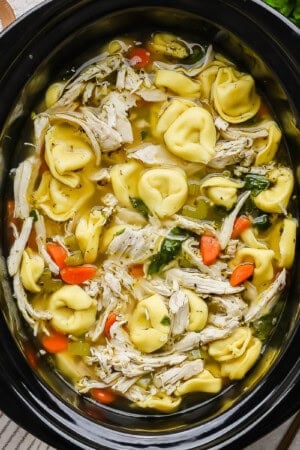 Slow cooker chicken tortellini soup in a slow cooker.
