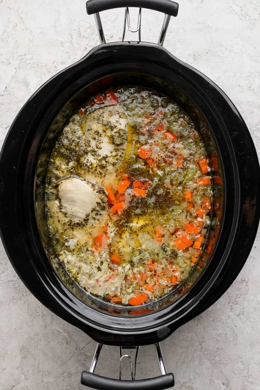 Cooked slow cooker chicken tortellini soup in slow cooker with un-shredded chicken breasts.